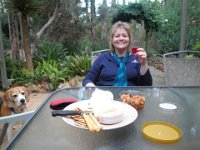 P5220668  Rauleigh enjoys a drink and snack on the patio at Bear's Den, Denmark.